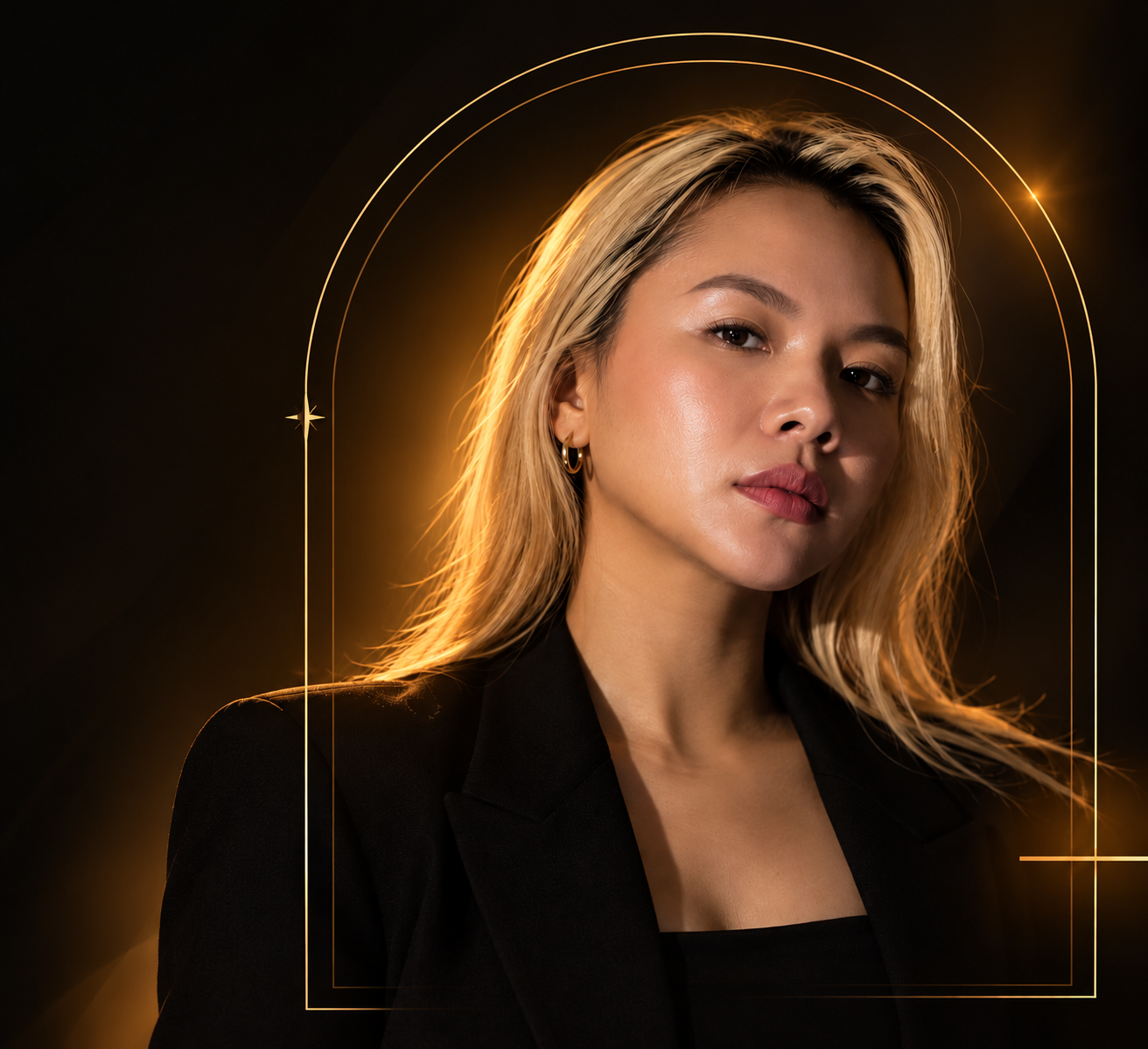 SuperMomPH in a black blazer, framed by a golden arch with warm cinematic lighting.